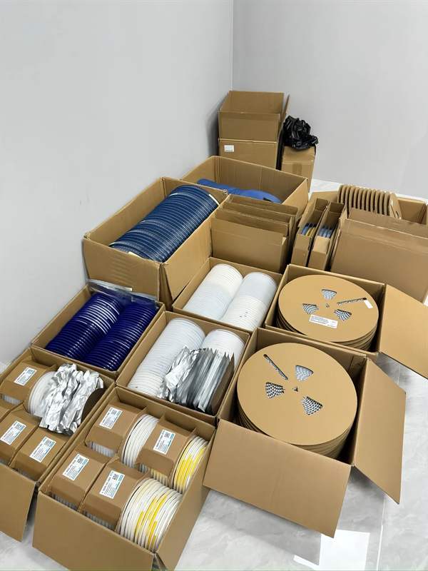 Rows of SMD IC reels in moisture barrier vacuum bags, with ST distributor label green tags.